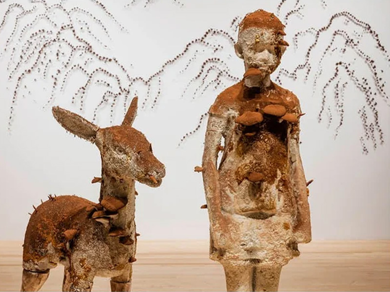 Artwork of a small person standing next to a deer, both with mushrooms growing out of their bodies