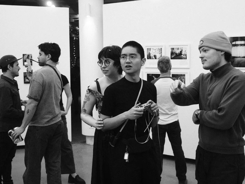 black and white photo of crowd viewing works at Exposure 2022